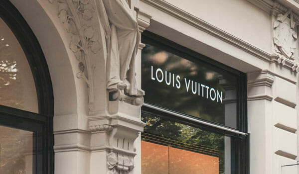 Customers leave a newly-opened Louis Vuitton (LV) flagship store